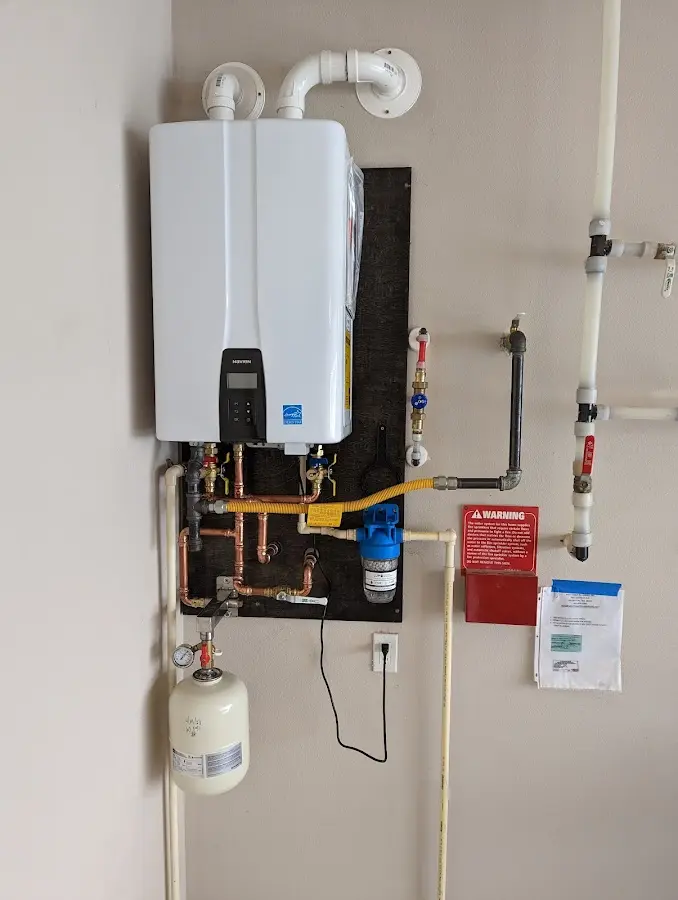 Professional plumber installing copper piping in a Asbury home